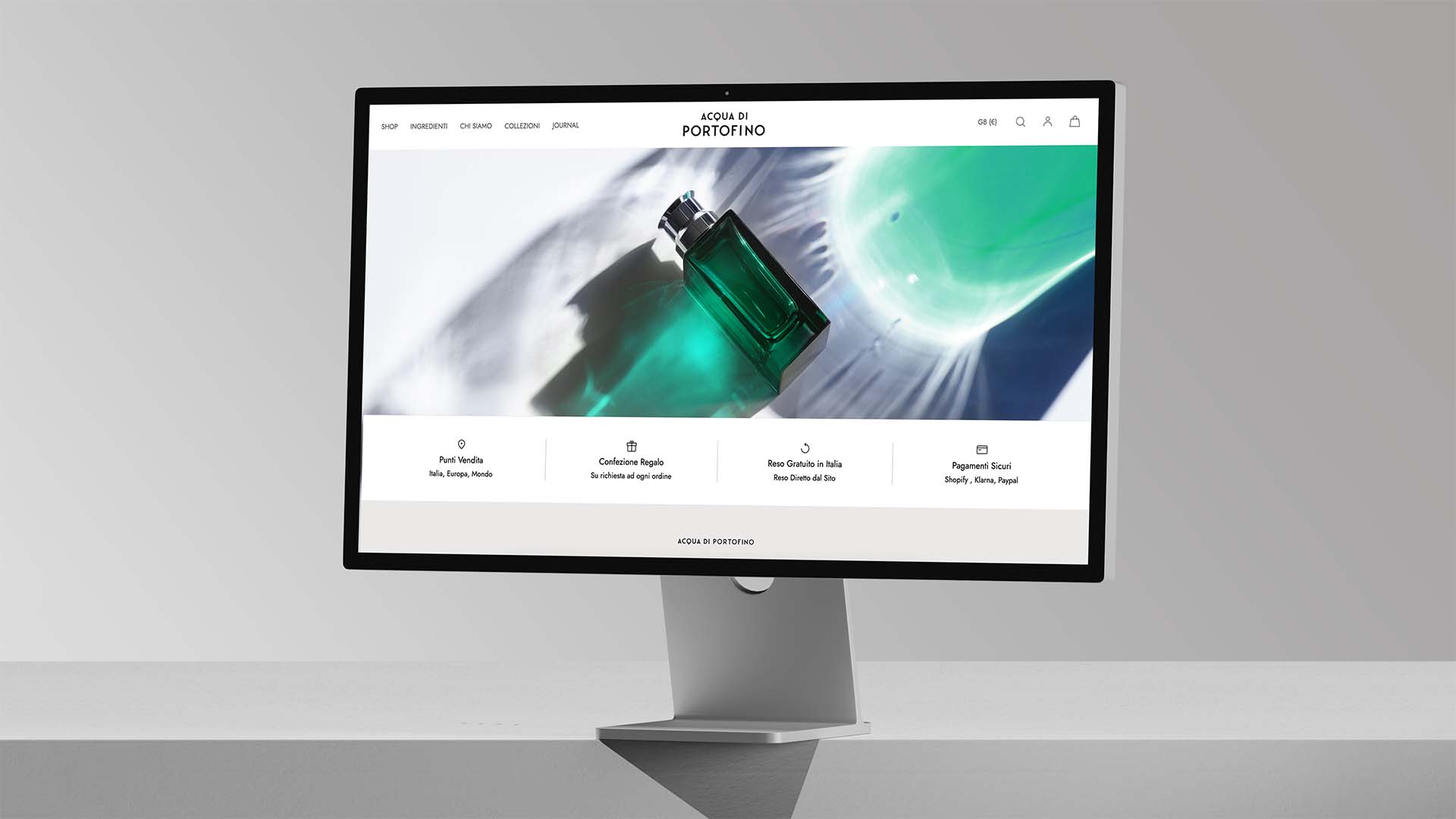 Desktop monitor showing the minimal online storefront layout and hero imagery for Acqua di Portofino.