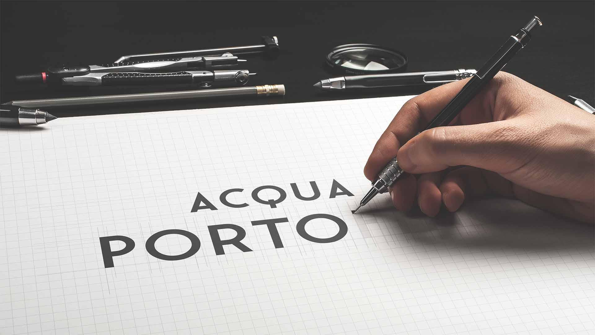 Hand drafting custom typography on grid paper surrounded by precision drafting tools and calipers.