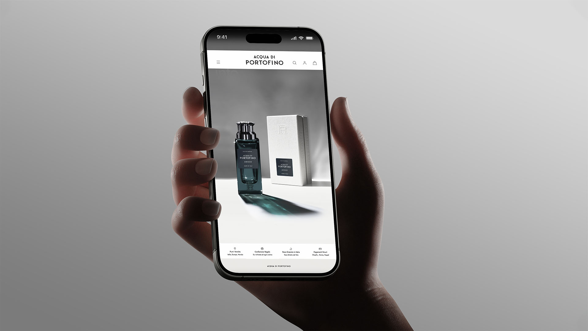 Hand holding an iPhone displaying the responsive mobile e-commerce layout for Acqua di Portofino.