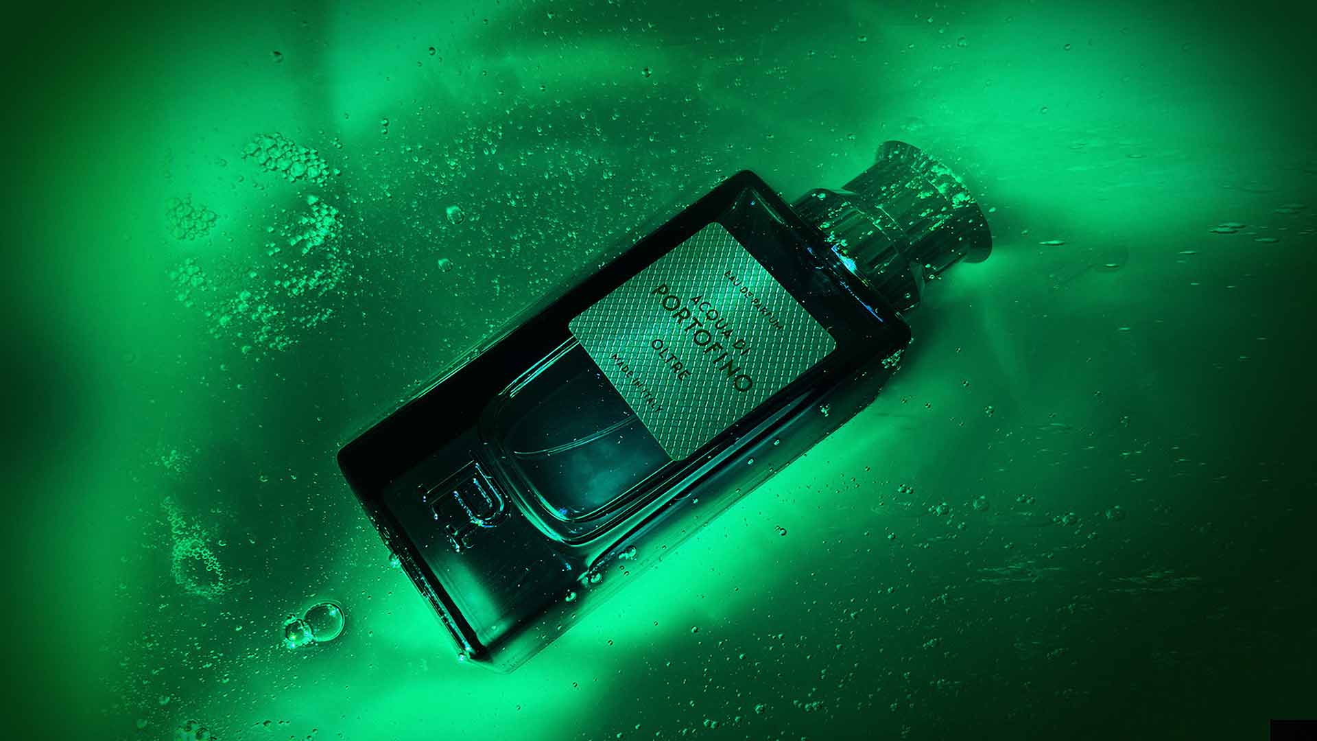 Acqua di Portofino Oltre Eau de Parfum glass bottle submerged in glowing green backlit liquid with air bubbles and light refractions.