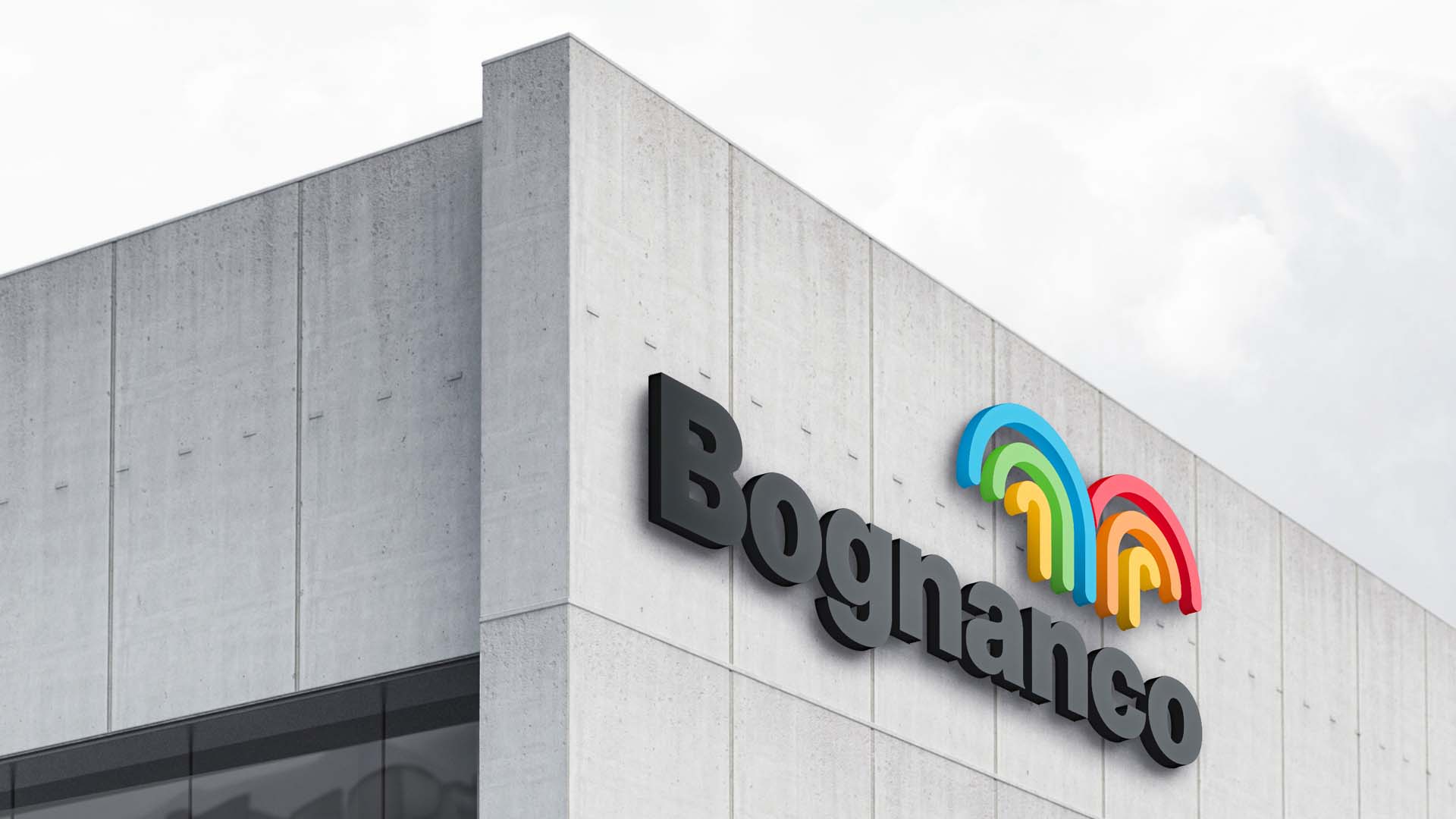 3D black exterior building logo and colorful fountain mark mounted on a concrete architectural facade.