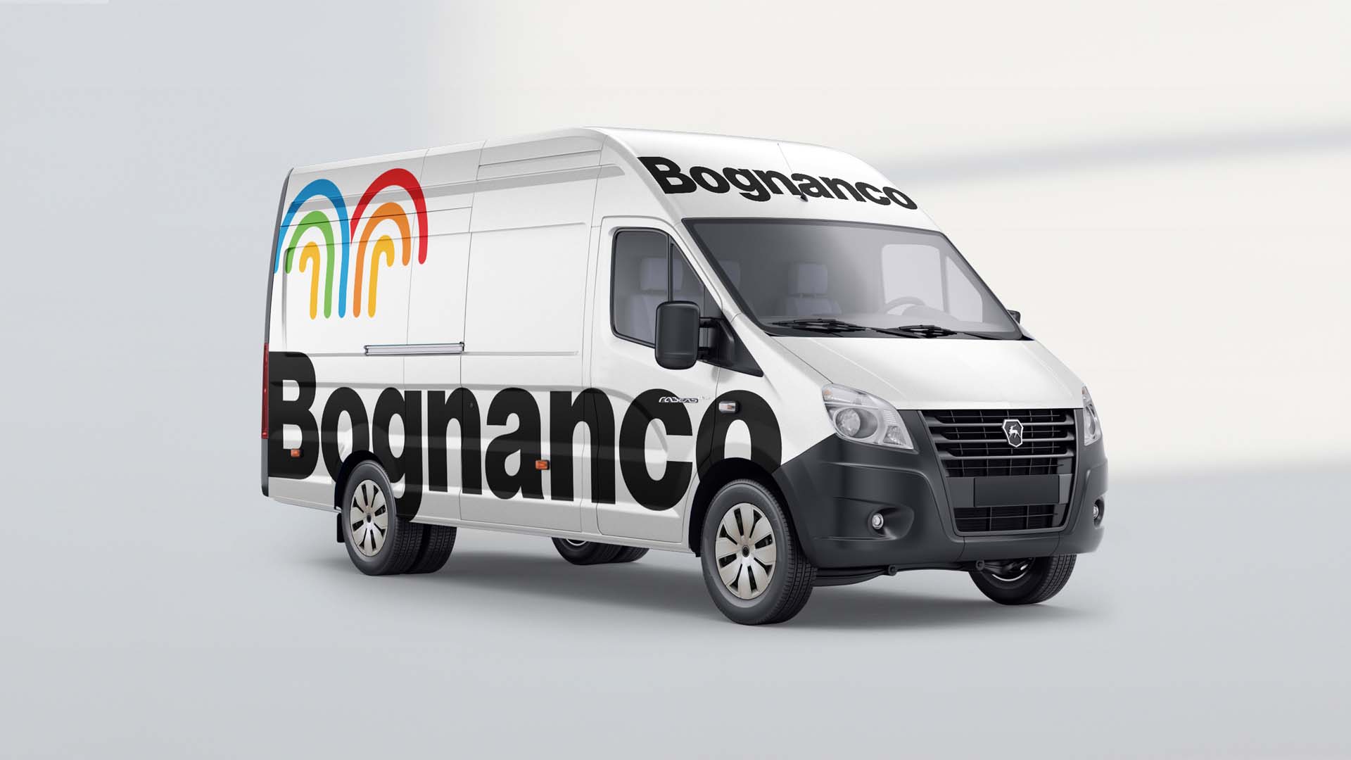 White commercial cargo van wrapped with oversized Bognanco side typography and fountain graphic.