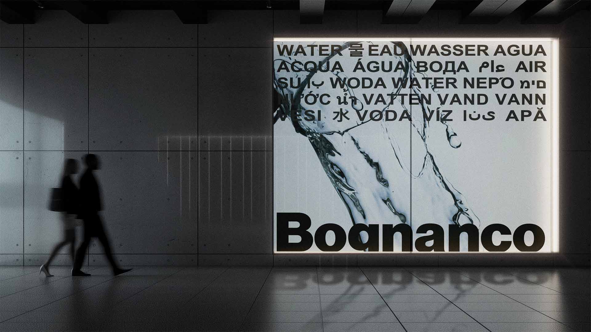 Large backlit transit advertising poster displaying multilingual water typography and splash photography.