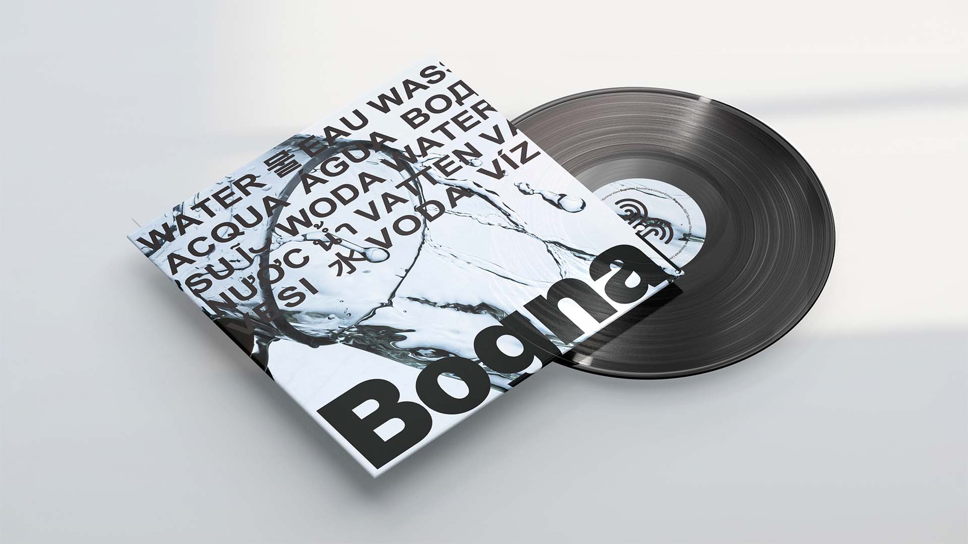 Black vinyl record disc resting beside a printed album sleeve featuring liquid splash typography.